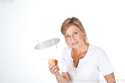 Image of Blond cute woman eating an apple
