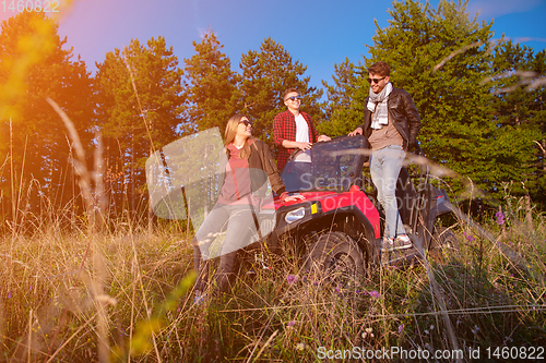 Image of group of young people driving a off road buggy car