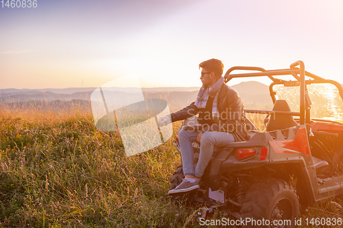 Image of portrait of young man driving a off road buggy car