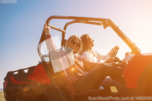 Image of two young women driving a off road buggy car