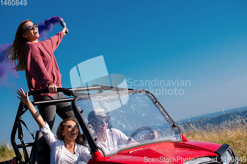 Image of group of young people having fun while driving a off road buggy 