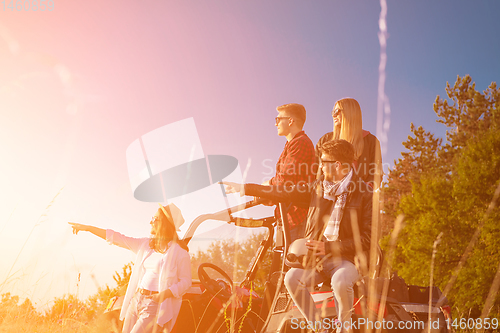 Image of group of young people driving a off road buggy car