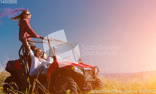 Image of group of young people having fun while driving a off road buggy 