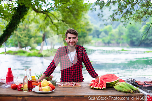 Image of Man putting spices on raw meat  for barbecue grill