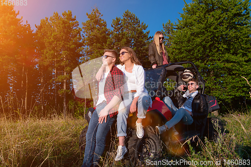 Image of group of young people driving a off road buggy car