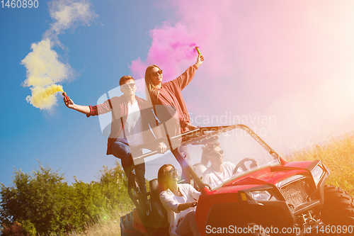 Image of group of young people having fun while driving a off road buggy 