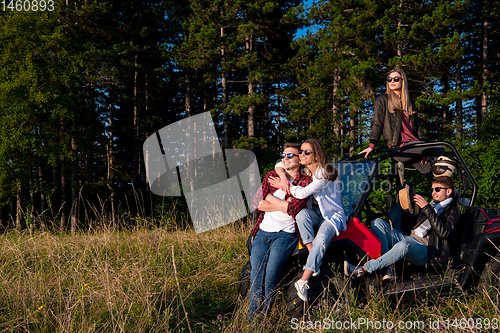 Image of group of young people driving a off road buggy car