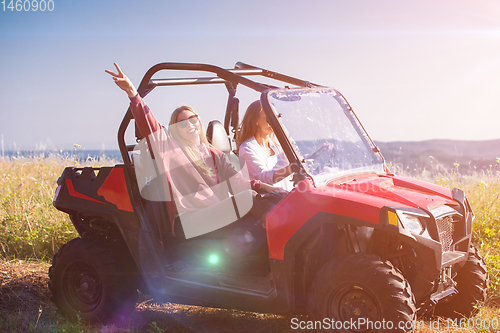 Image of two young women driving a off road buggy car