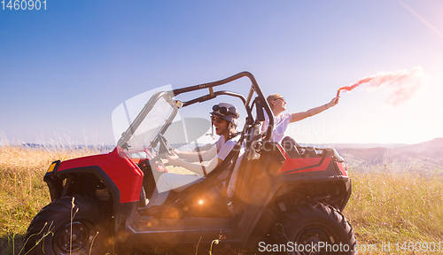 Image of group of young people having fun while driving a off road buggy 