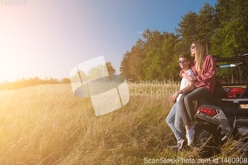 Image of young couple driving a off road buggy car