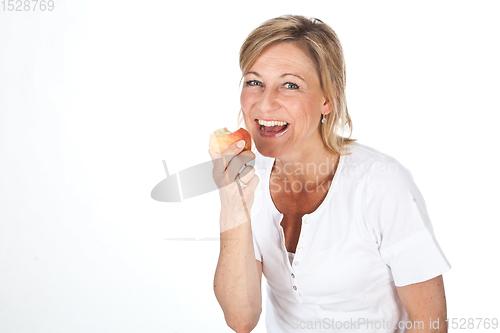 Image of Blond cute woman eating an apple