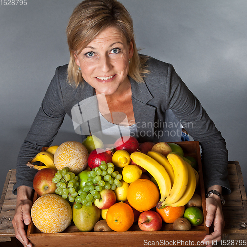 Image of Fruits and blond cute woman