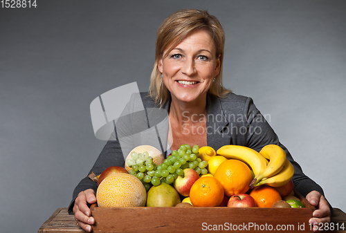 Image of Fruits and blond cute woman