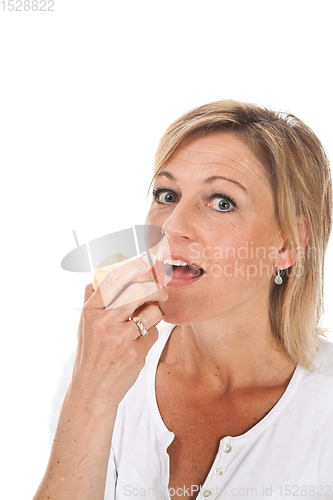 Image of Blond cute woman eating an apple