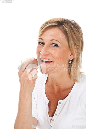 Image of Blond cute woman eating an apple