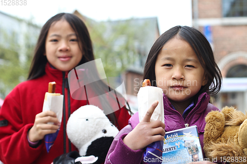 Image of Girls eating a sausage