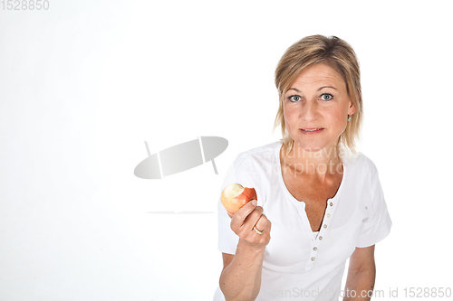 Image of Blond cute woman eating an apple
