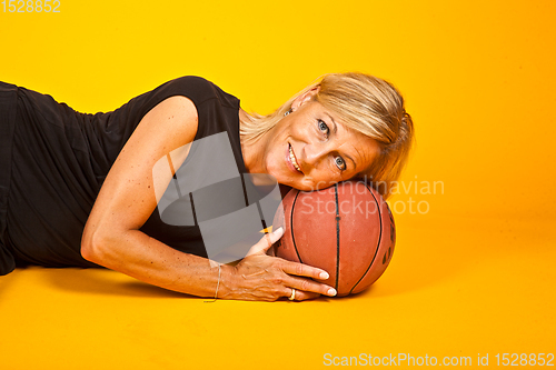 Image of woman posing with a basket ball