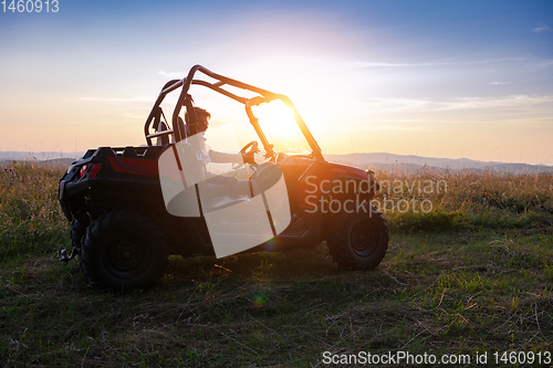 Image of portrait of young man driving a off road buggy car