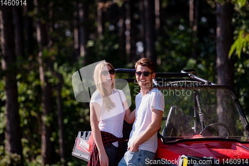 Image of young couple driving a off road buggy car
