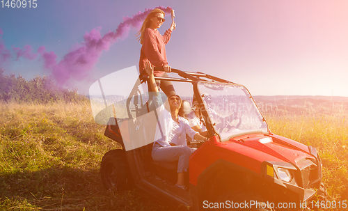 Image of group of young people having fun while driving a off road buggy 