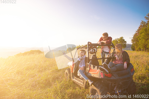 Image of group of young people driving a off road buggy car