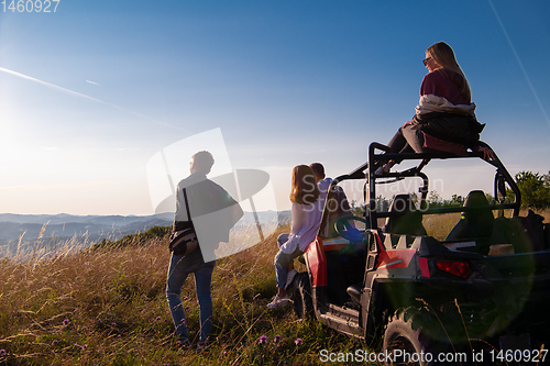 Image of group of young people driving a off road buggy car