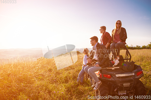 Image of group of young people driving a off road buggy car
