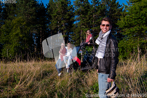 Image of group of young people driving a off road buggy car