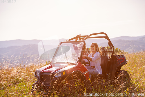 Image of two young women driving a off road buggy car