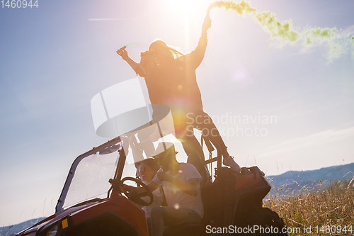 Image of group of young people having fun while driving a off road buggy 