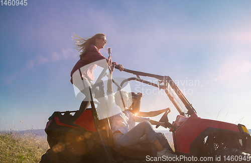 Image of group of young people having fun while driving a off road buggy 