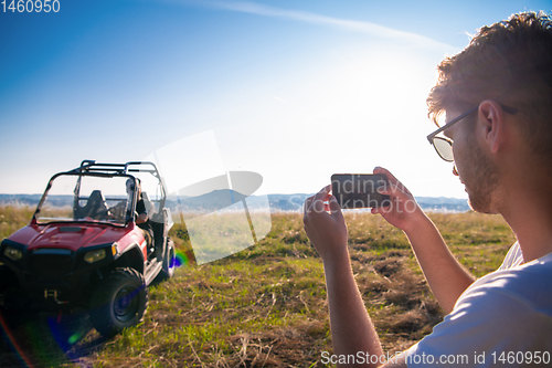 Image of two young men having fun while driving a off road buggy car