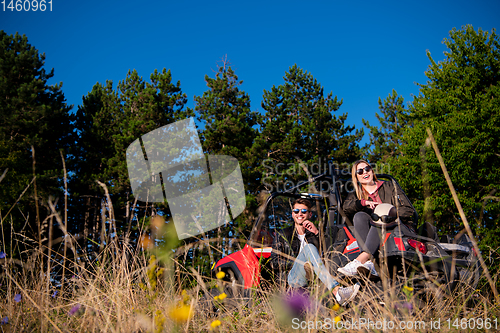 Image of young couple driving a off road buggy car