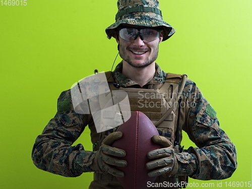 Image of solder holding american football ball