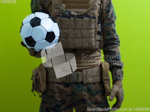 Image of solder holding soccer  ball