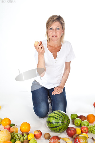 Image of Blond cute woman eating an apple