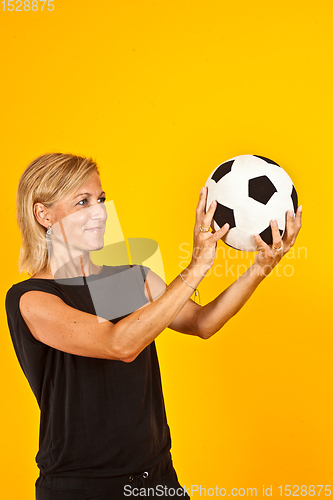 Image of woman playing with a soccer ball