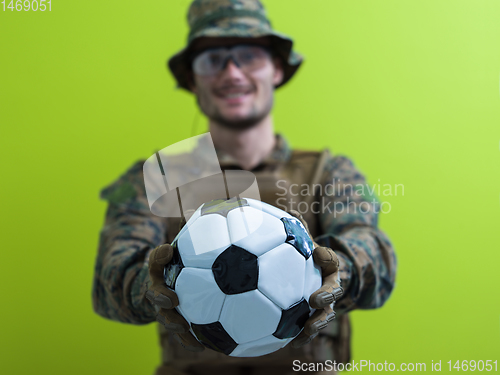 Image of solder holding soccer  ball