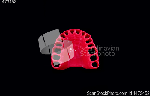 Image of model of human gums without teeth isolated on black
