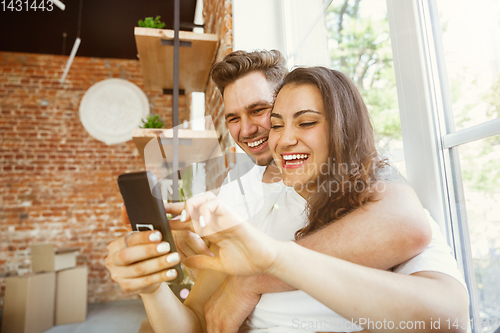 Image of Young couple moved to a new house or apartment