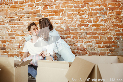 Image of Young couple moved to a new house or apartment