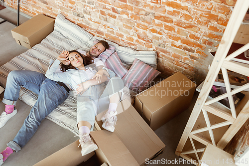 Image of Young couple moved to a new house or apartment