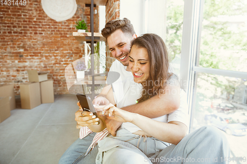 Image of Young couple moved to a new house or apartment