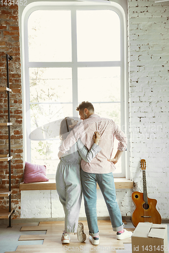 Image of Young couple moved to a new house or apartment