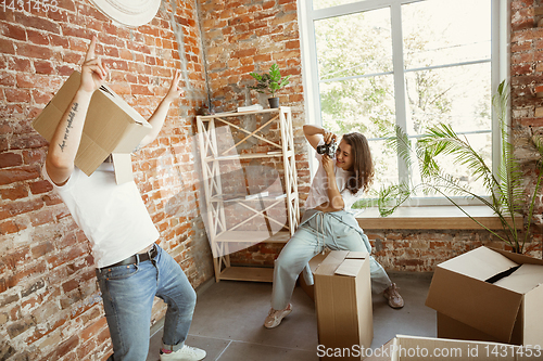 Image of Young couple moved to a new house or apartment