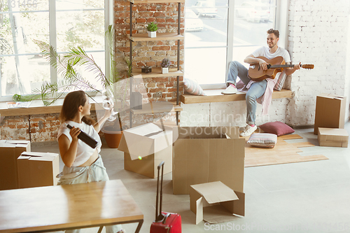 Image of Young couple moved to a new house or apartment