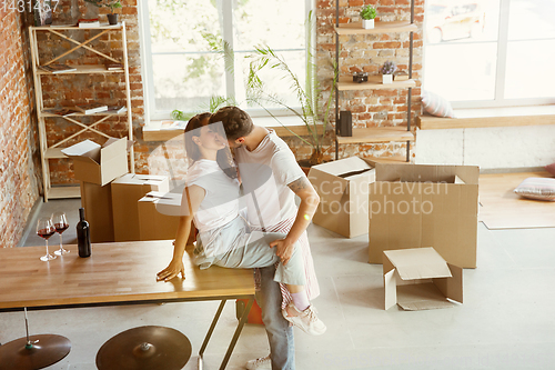 Image of Young couple moved to a new house or apartment