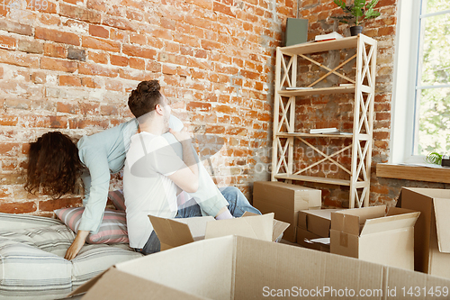 Image of Young couple moved to a new house or apartment