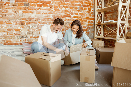 Image of Young couple moved to a new house or apartment